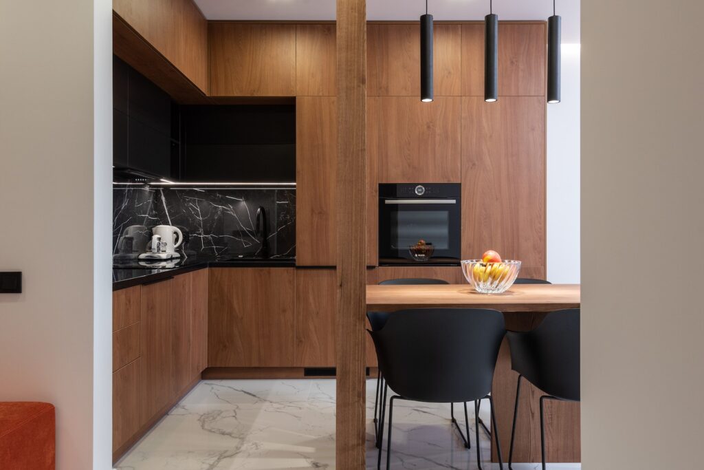 Wooden furniture and table in contemporary kitchen with dining zone