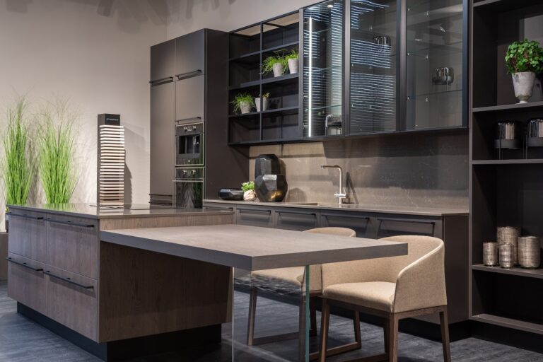Modern trendy kitchen interior with dark cabinets and counter in spacious contemporary flat